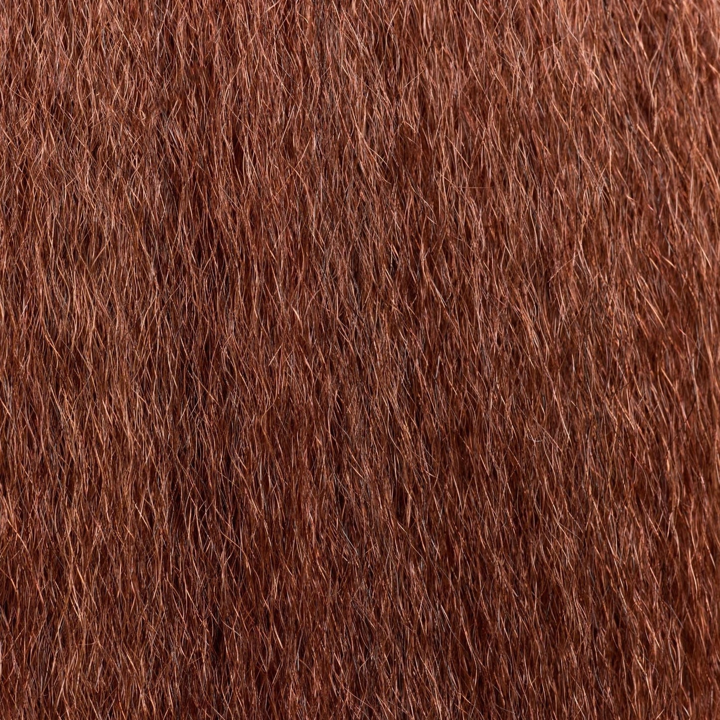 A close-up of kinky straight hair extensions in a rich auburn shade, featuring a soft, voluminous texture that mimics natural blow-dried hair. These luxury textured hair extensions provide a full-bodied look with a lightweight, natural feel, blending seamlessly with coarse hair textures. The high-quality strands offer versatility for styling, making them ideal for protective styles, added length, and effortless volume.