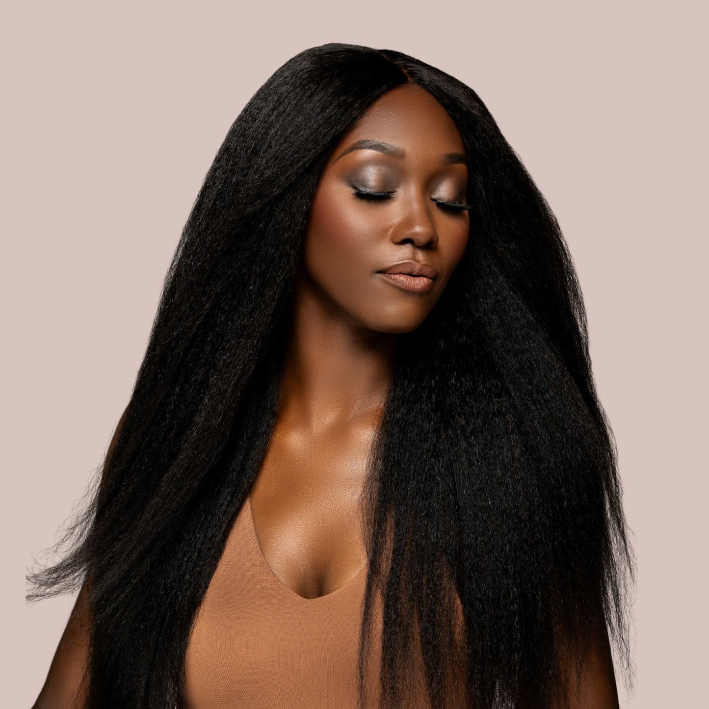Model wearing Miix Mii Hair Co. kinky straight extensions, styled in a sleek middle part with soft volume and natural texture. Hair mimics the look of blown-out natural hair.