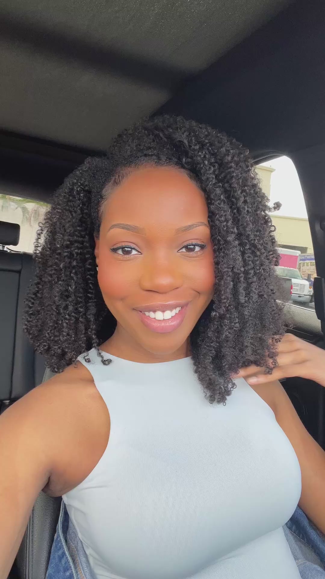 A woman with Lush Coil Curl Clip-ins that blend perfectly with type 4 hair.